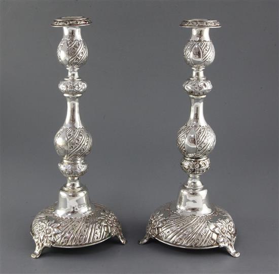 A pair of late Victorian repousse silver Sabbath day candlesticks by Moses Salkind, 34.6cm.